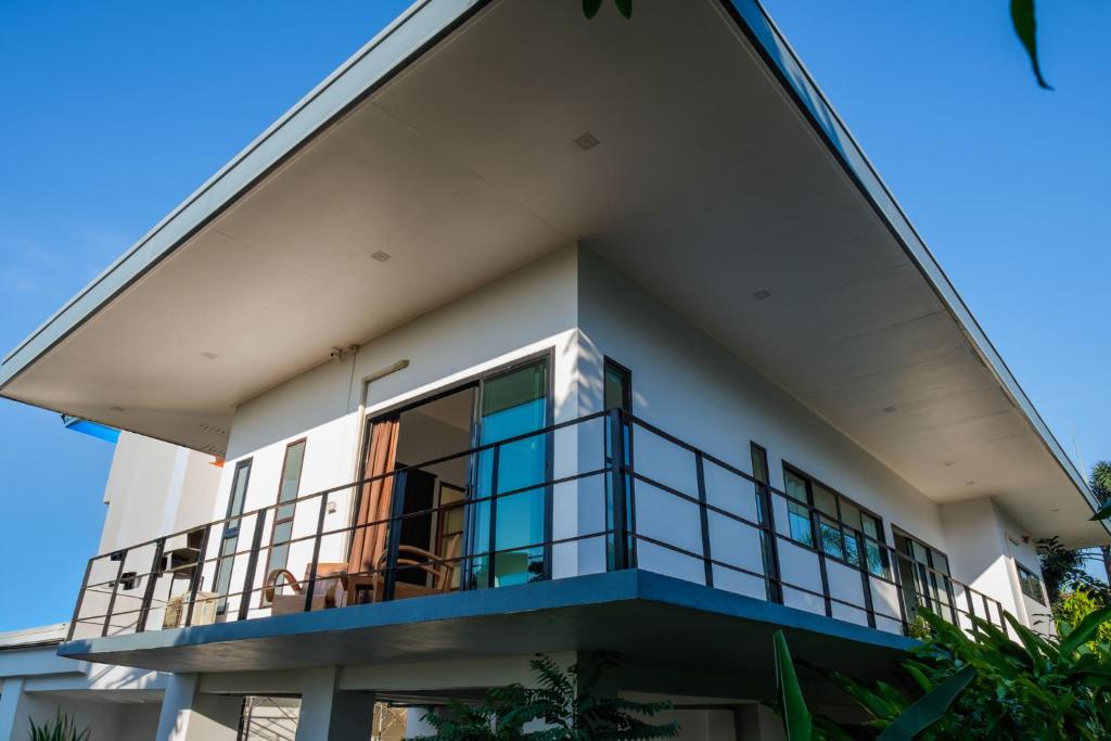 a large white house with a balcony at Sam Lanta in Ko Lanta