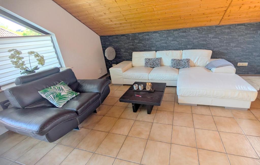 a living room with a couch and a table at FeWo bei Idar-Oberstein in Dickesbach