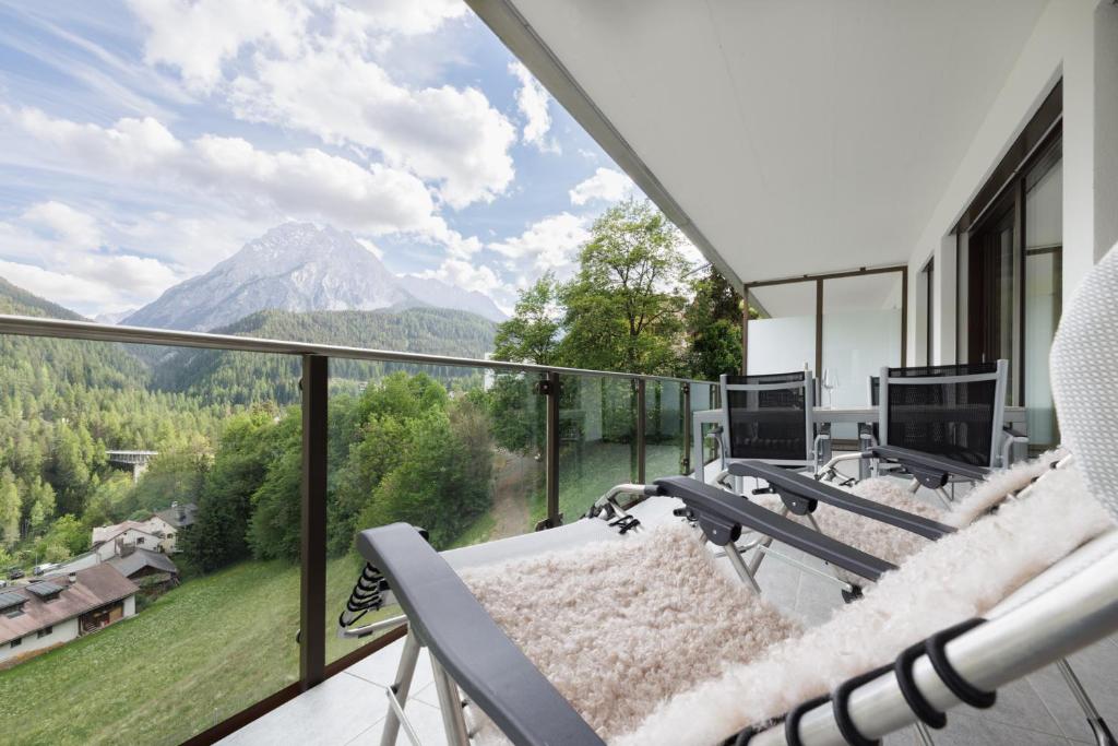 a balcony with a view of a mountain at Chasa Miramunt 2 in Scuol