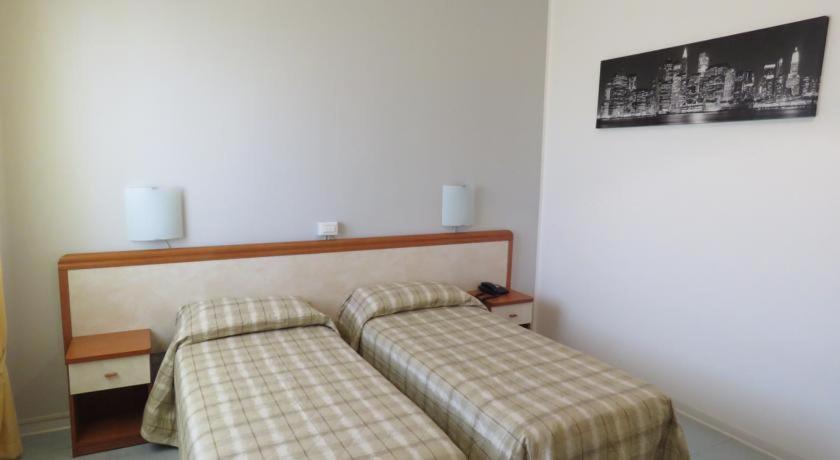 A bed or beds in a room at Hotel Marta