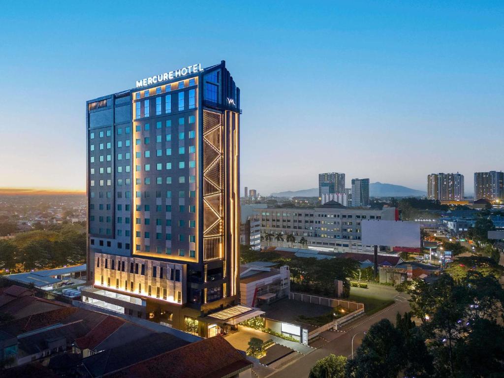 a tall building with a sign on top of it at Mercure Tangerang Centre in Tangerang
