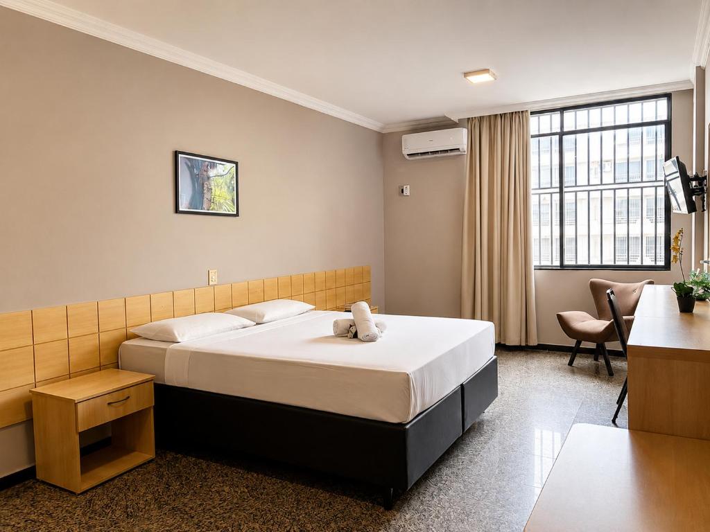 a bedroom with a bed with a teddy bear on it at Hotel Diplomat by Bsb Inn in Brasília