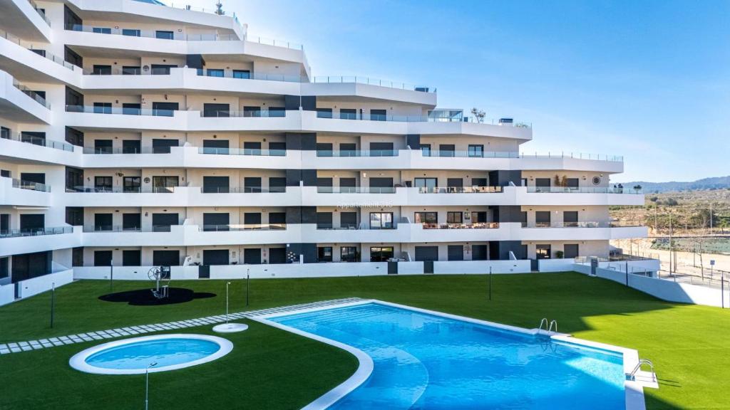a large apartment building with a large swimming pool at Paradise Resort 315 in San Miguel de Salinas