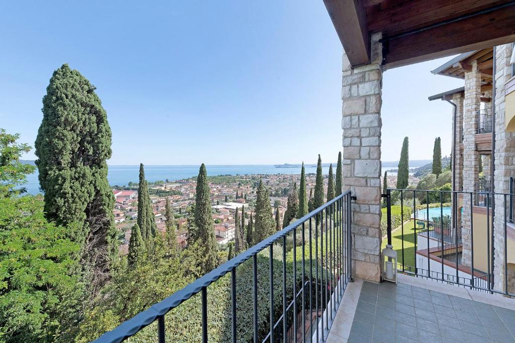 a balcony with a view of a city at Casa 3 Rose Lake View and Pool in Toscolano Maderno