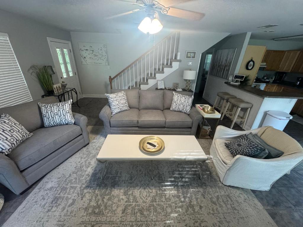 a living room with a couch and a coffee table at Sleepy Lagoon Cottage in Covington