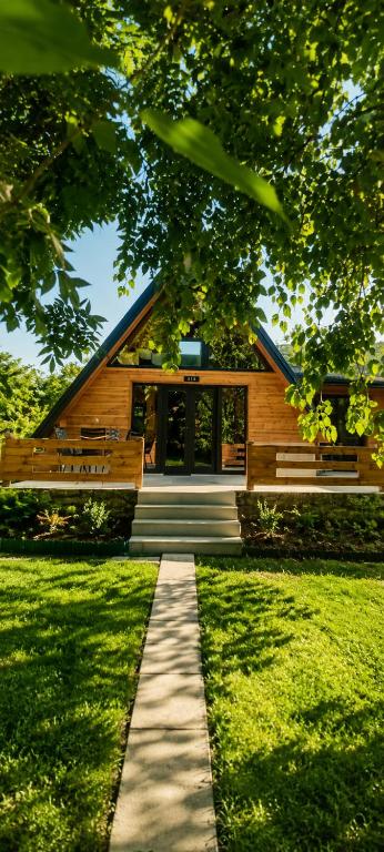 a wooden house with a pathway in front of it at Trebižat Oasis in Čapljina