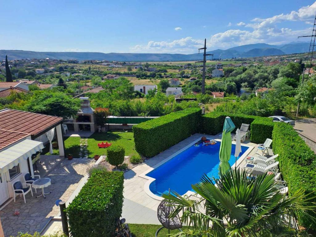 a house with a swimming pool in a yard at Villa Panorama Blagaj in Blagaj