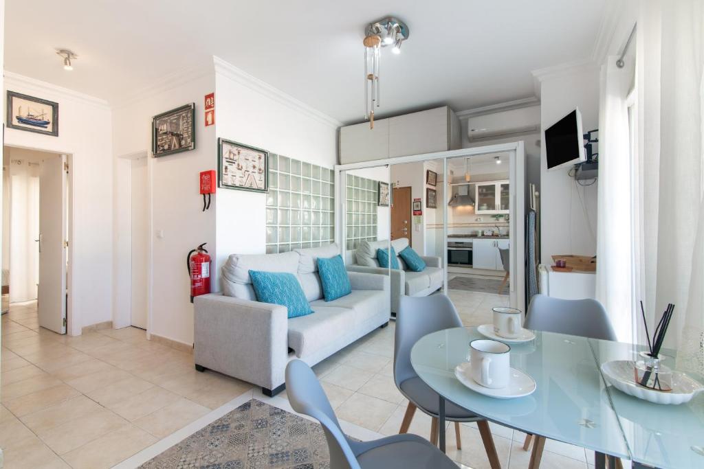 a living room with a table and a couch at Casa Lori Albufeira in Albufeira