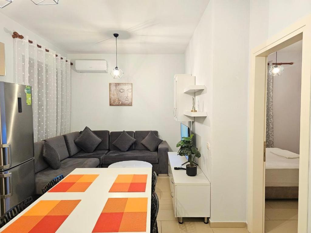 a living room with a couch and a table at 07 Apartment Vlore in Vlorë