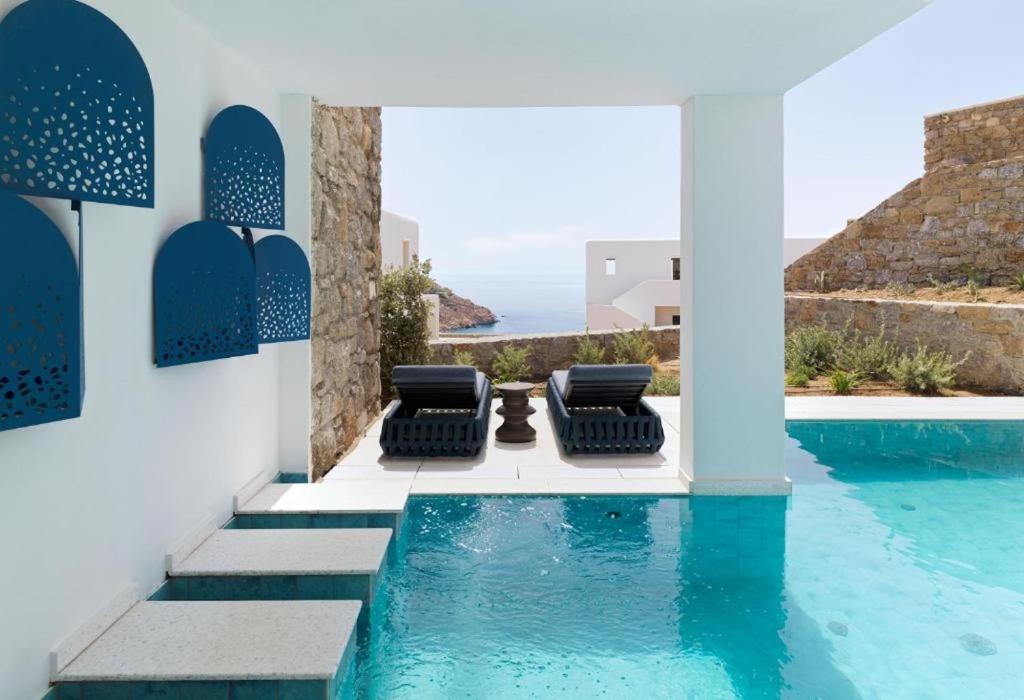 a villa with a pool and a view of the ocean at LYO II Boutique Suites in Mikonos