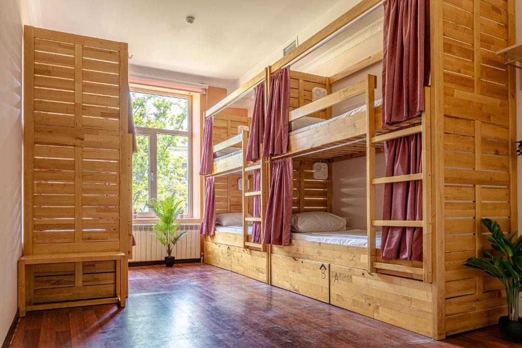 a large room with bunk beds in a house at Sahil Bay Hostel in Baku