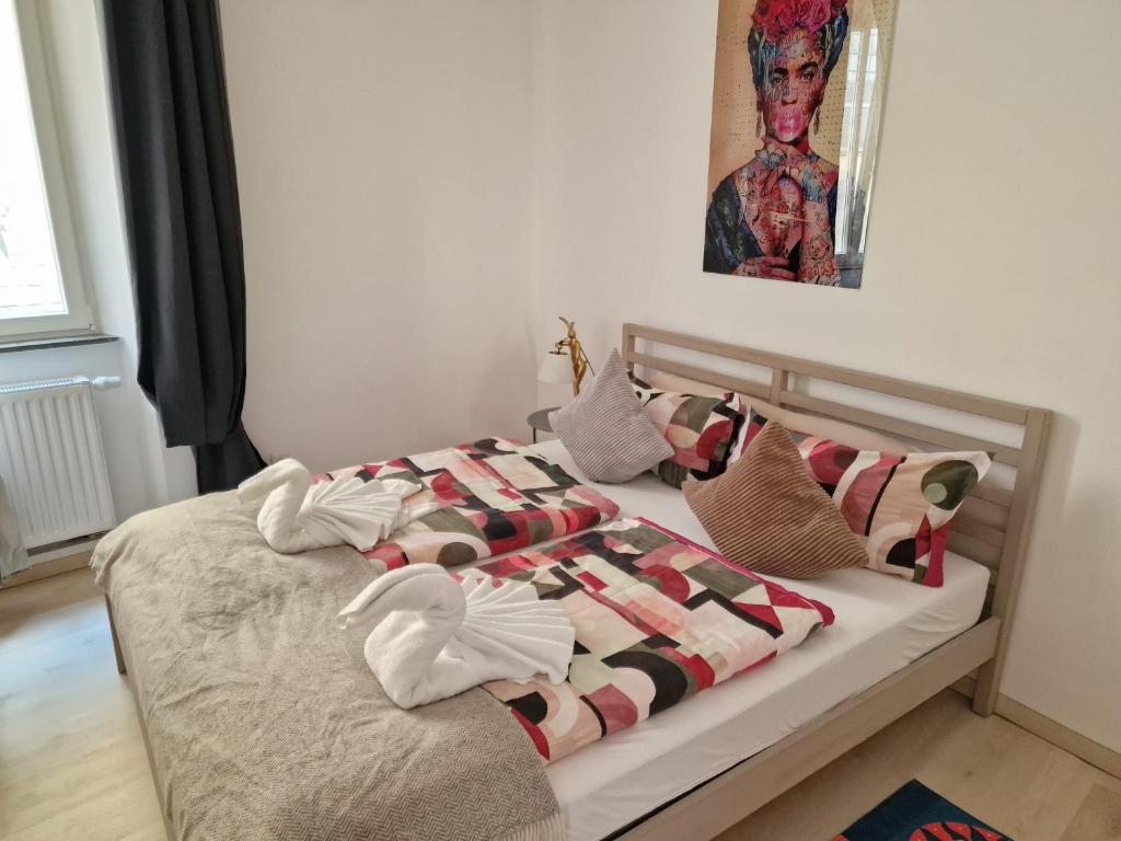 a bed with pillows on it in a bedroom at Art House Olymp in Bamberg