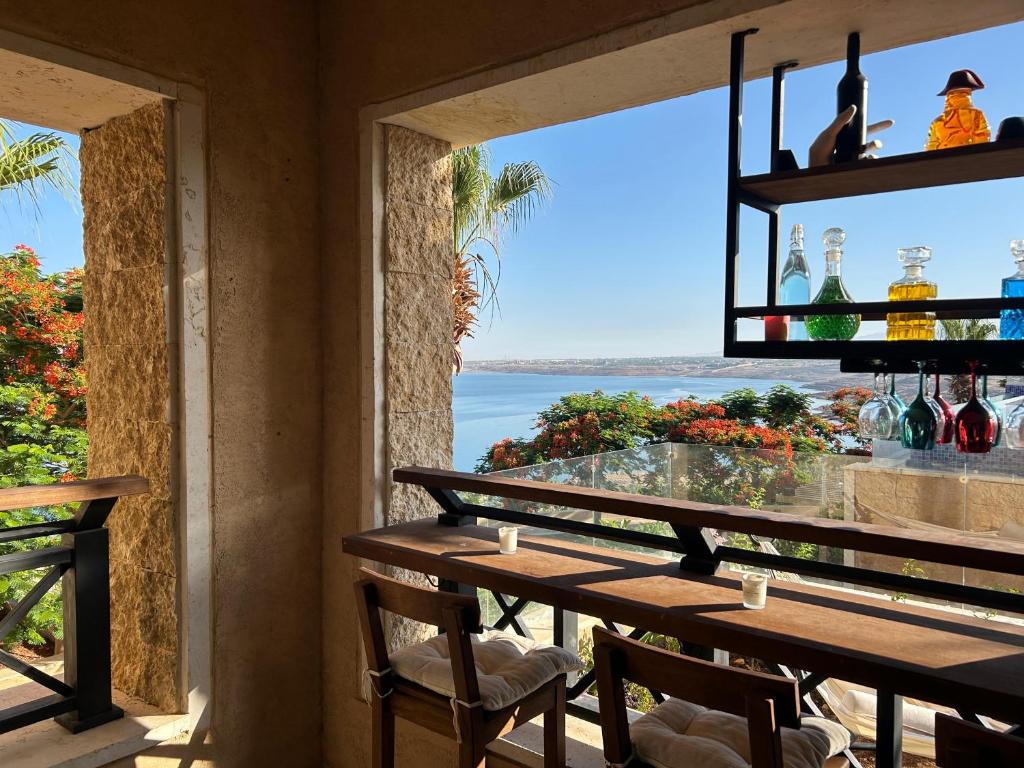 a restaurant with a table with a view of the ocean at Samarah E 01 full Sea View and adult pool prime location with garden , in Al Baḩḩāth