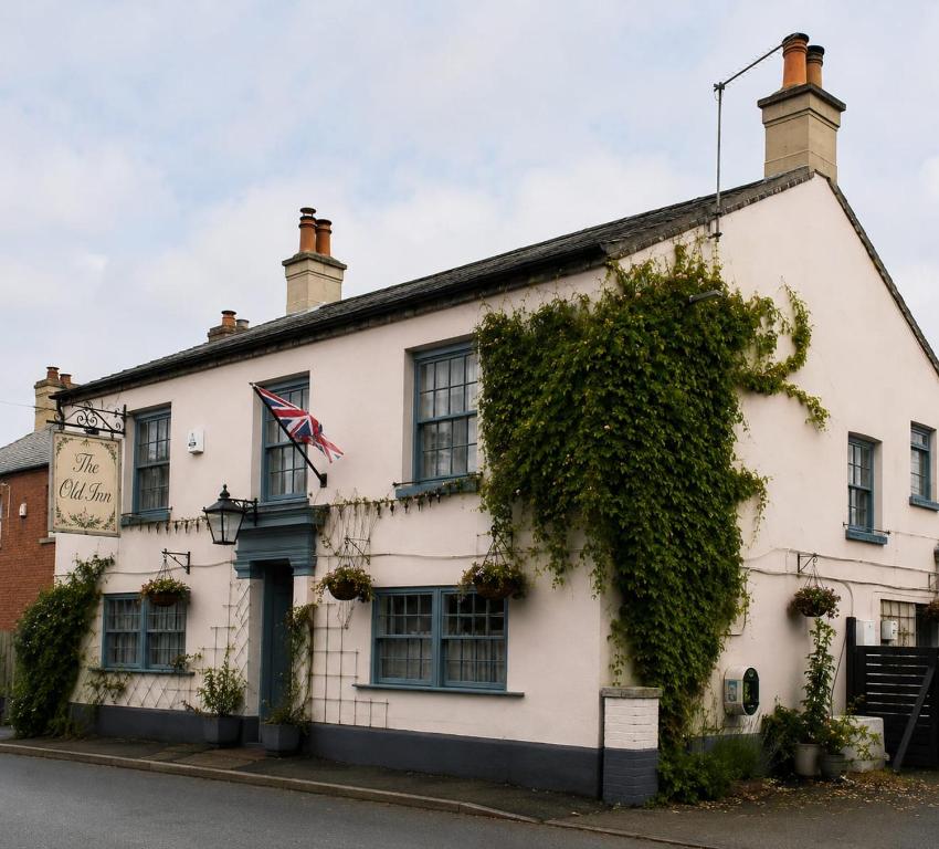 an old white building with a flag on it at 5 Bed in Hundleby oc-o44769 in Spilsby