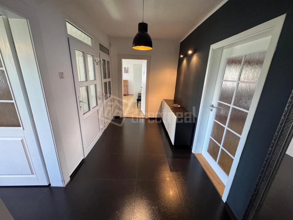 a hallway with a white door and a black floor at Byt Staré Mesto in Liptovský Mikuláš