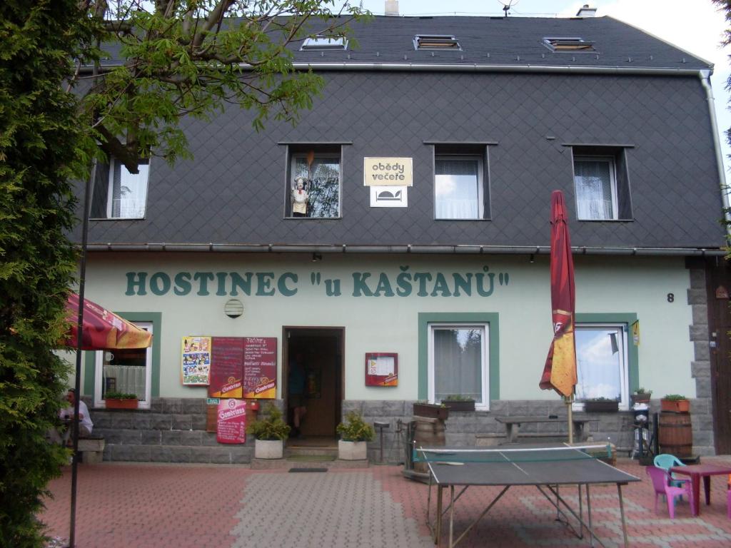 a building with a tennis table in front of it at Pension U Kaštanů in Karlovy Vary