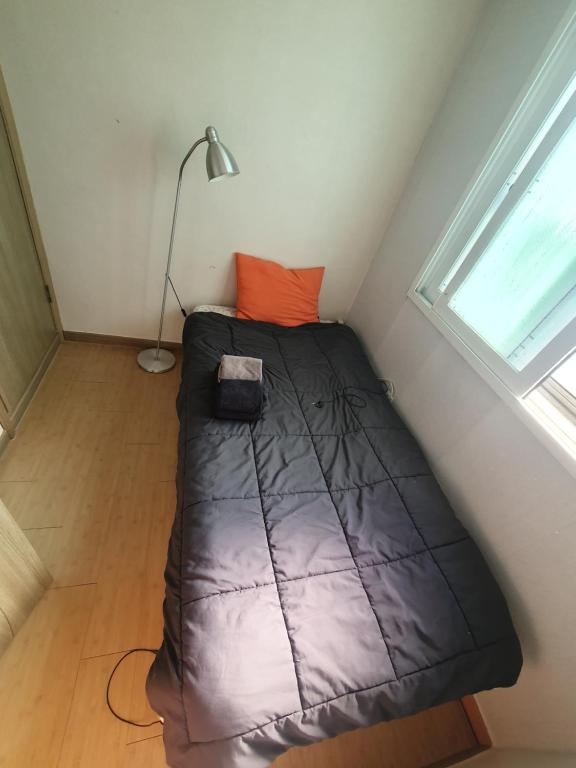 a small bed in a room with a window at 1room 1bed Gangnam in Samgong