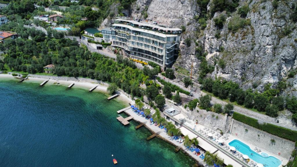 an aerial view of a hotel on a cliff next to the water at HOTEL ASTOR in Limone sul Garda