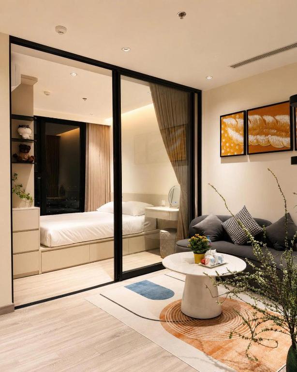a living room with a bed and a couch at AnVy house Skyforest 2 Ecopark in Xuân Quan