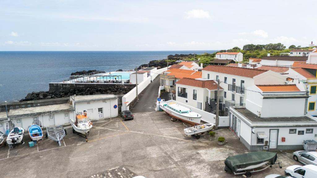 an aerial view of a town with boats in a parking lot at Casa do Porto - Santa Cruz B&B in Ribeiras