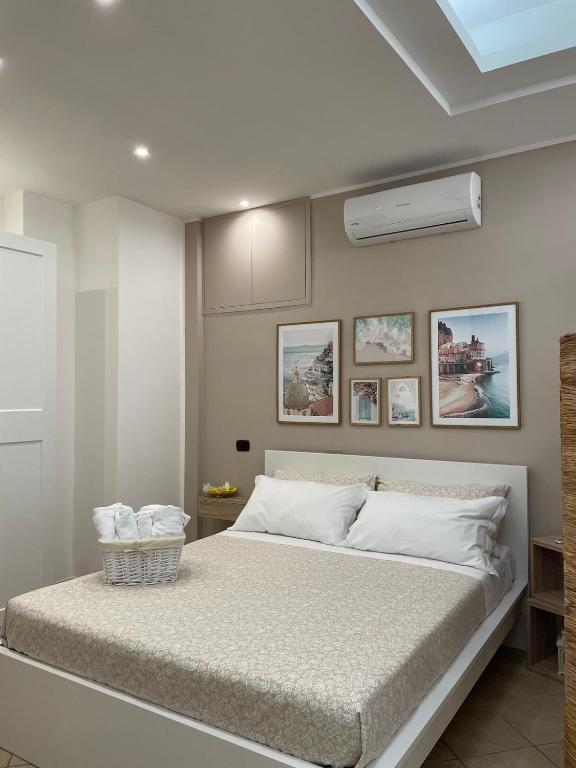 a bedroom with a large bed with white pillows at Carla's studio in Pompei
