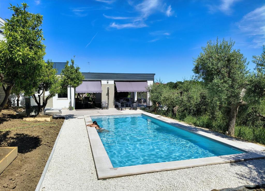 a person laying in a swimming pool in a house at Borgo Ragnitill in Lanciano