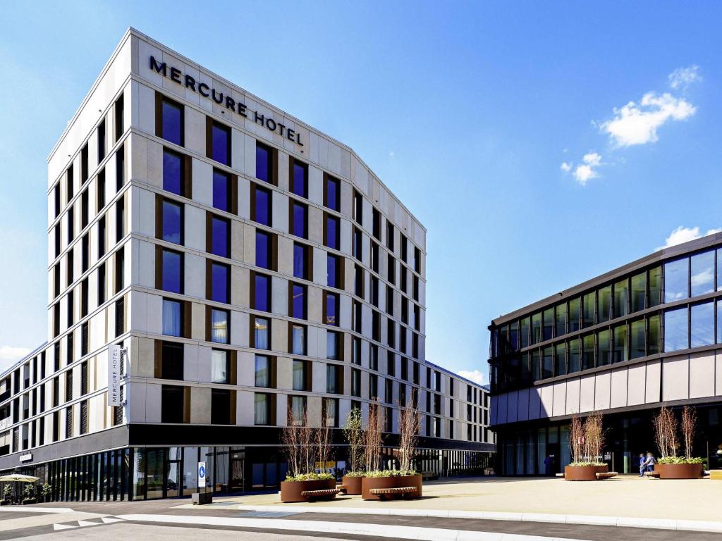 a building with a sign on the front of it at Mercure Hotel Delémont in Delémont