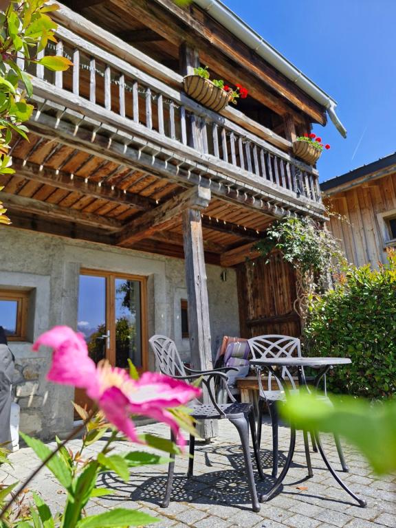 a table and chairs in front of a house at Couples Gem - Sensational views Nr Morzine in La Côte dʼArbroz