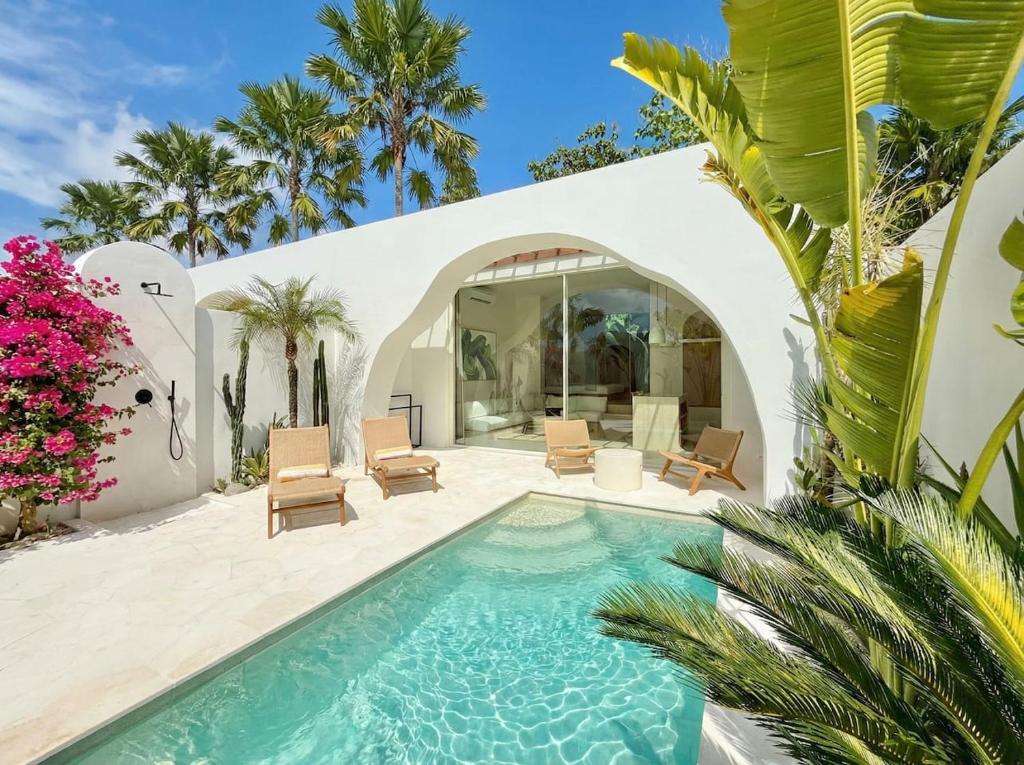 a pool in the backyard of a house at Dolce Suites in Uluwatu