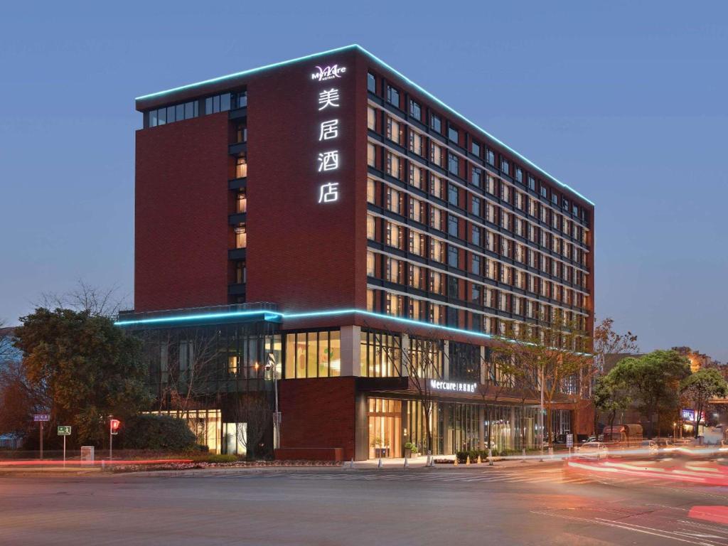a building with a sign on the side of it at Mercure Chengdu Shuangliu in Chengdu