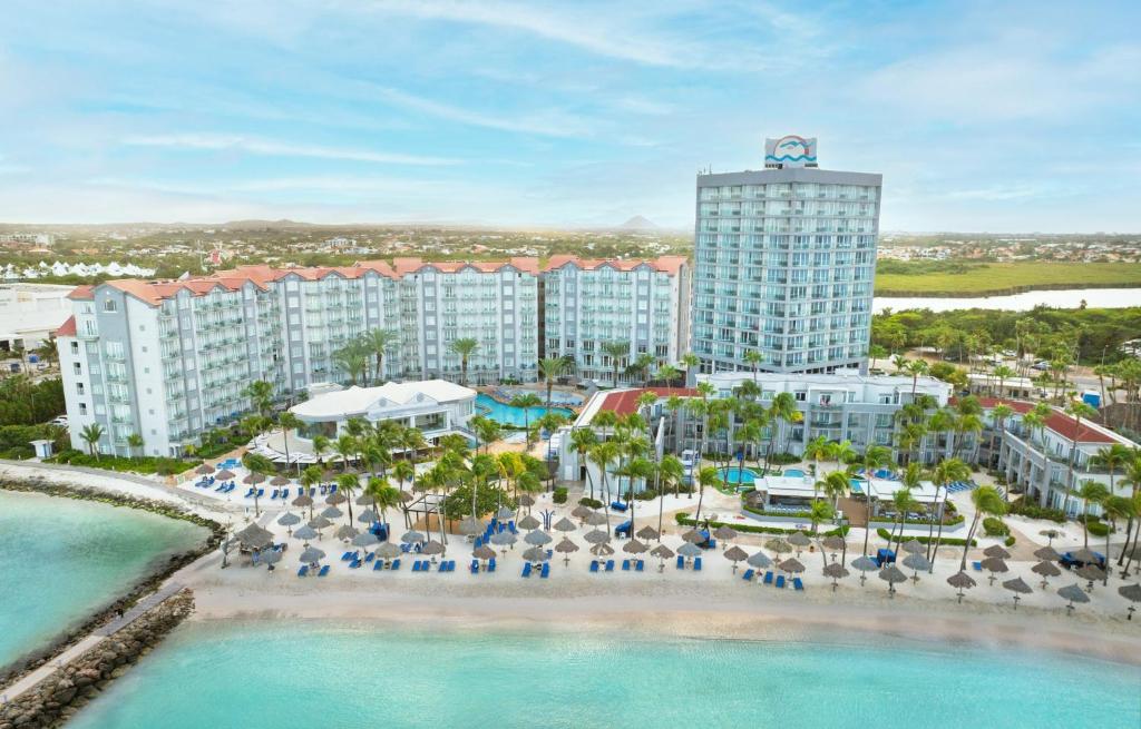 an aerial view of a resort with a beach and buildings at Divi Aruba Phoenix Beach Resort in Palm-Eagle Beach