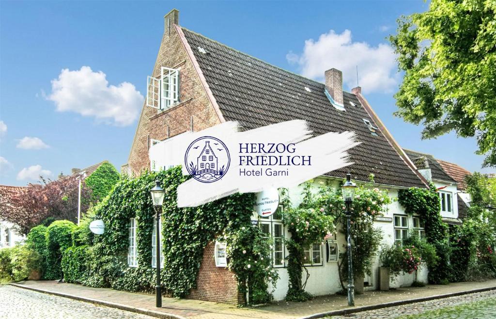 a building with a sign in front of it at Herzog Friedlich Hotel Garni in Friedrichstadt