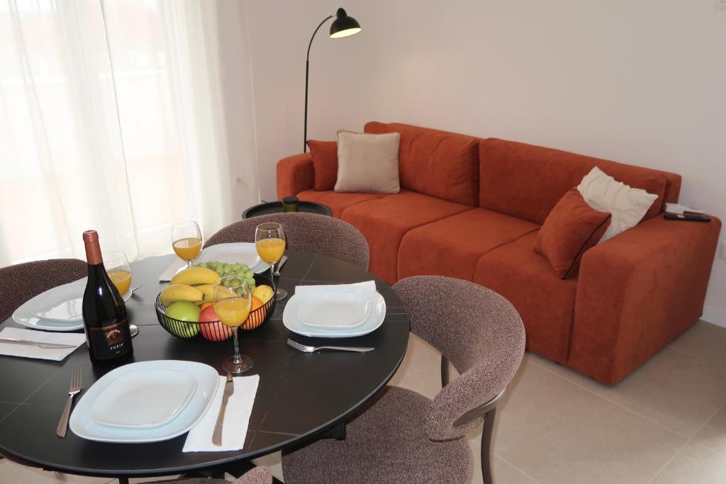 a living room with a table and a couch at Dalmatinac Residence in Orebić