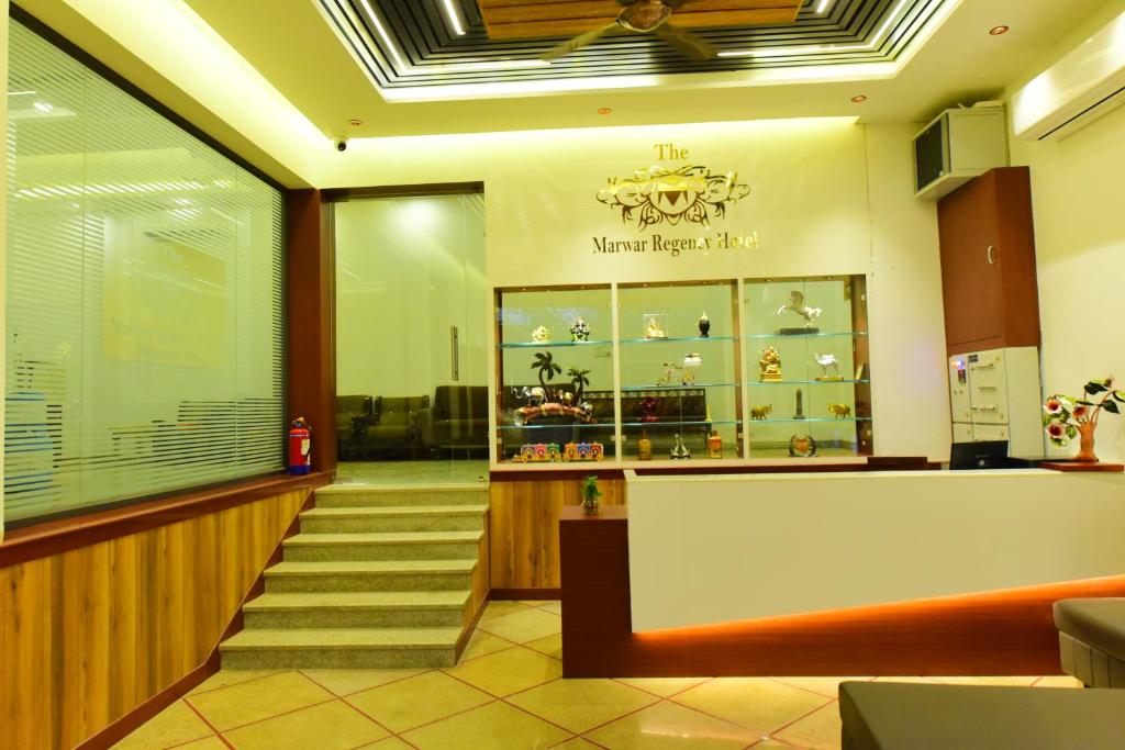 a lobby of a shoe store with a staircase at The Marwar regency Hotel in Jodhpur