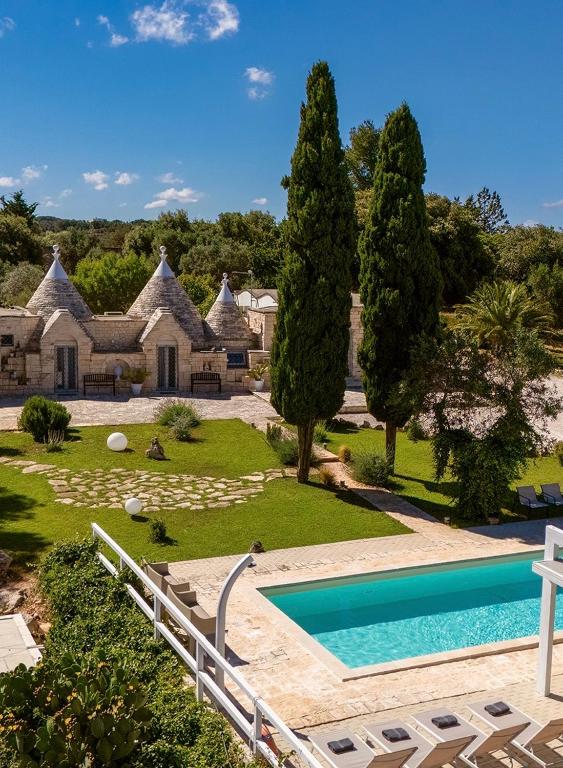 an image of a house with a swimming pool at Trullo Theodoro Puglia in Ceglie Messapica