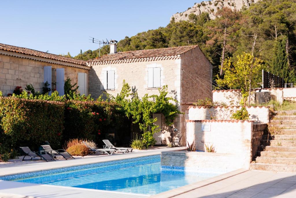 a house with a swimming pool next to a building at Château Catherine de Montgolfier - B&B et Gites - Piscine - Domaine viticole bio avec dégustation in Narbonne