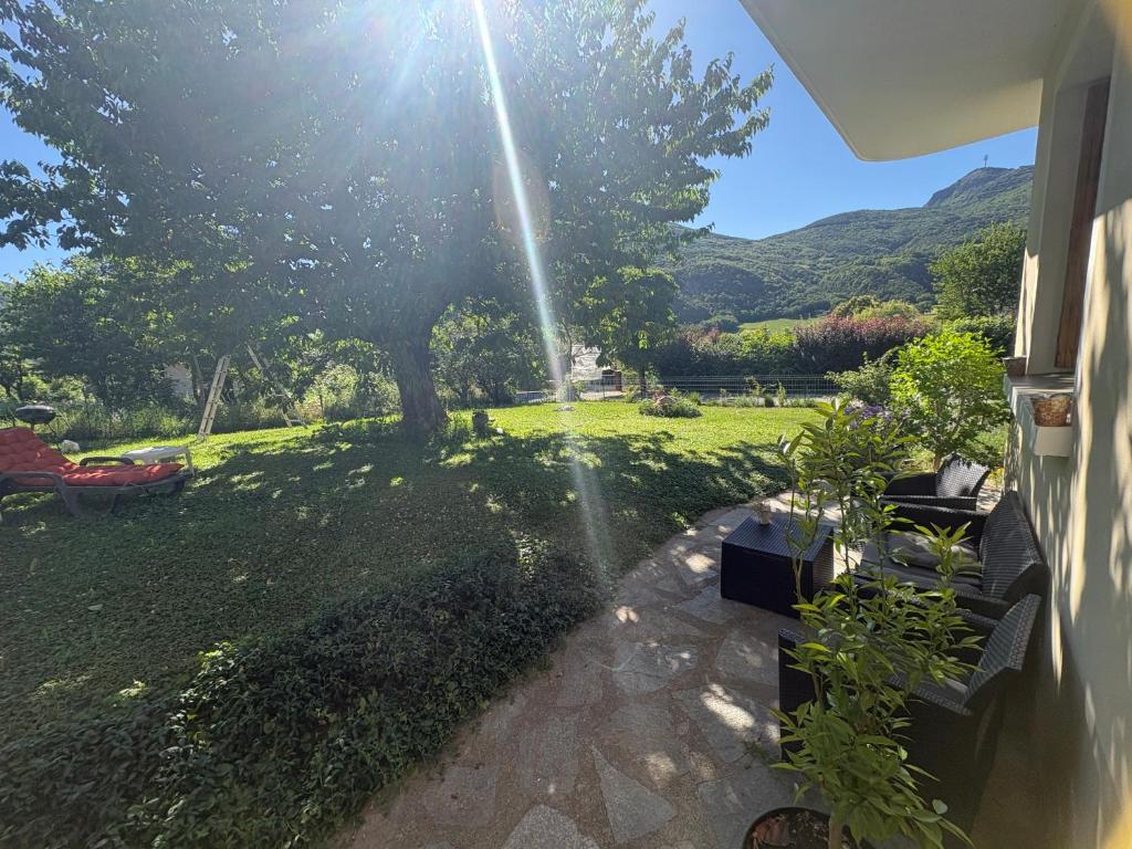 a house with a sprinkler spraying water on a yard at Le petit gîte in Saint-Étienne-le-Laus