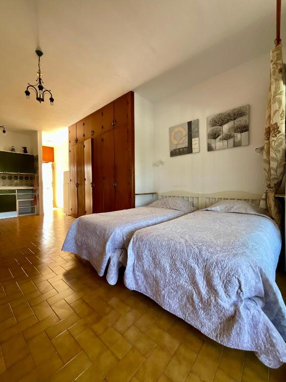 a bedroom with a large bed and a wooden floor at Trebol 1 in Costa Del Silencio
