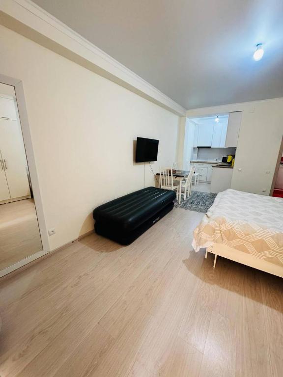 a large bedroom with a bed and a kitchen at 1apartment on First Line-Bosteri in Bosteri
