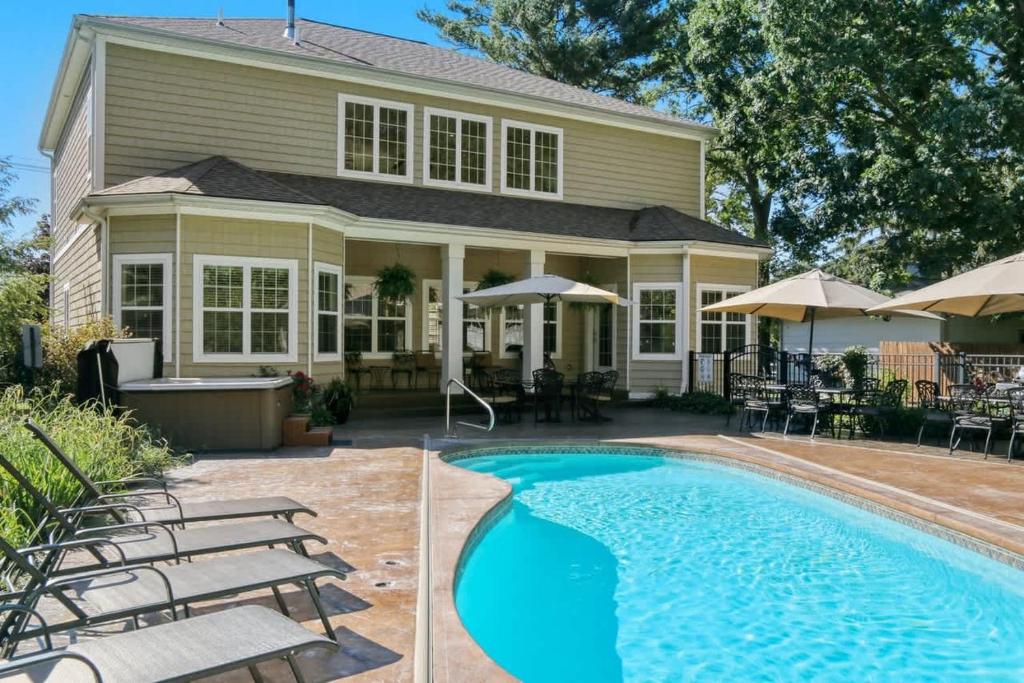 a house with a swimming pool in front of a house at Inn Like a Lamb in South Haven