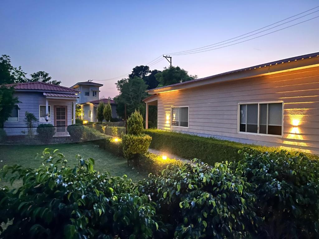 a house with lights in the yard at Corbett VEDA INN in Rāmnagar