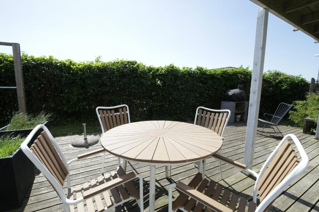 a table and chairs on a wooden deck at id123 Karl Andersensvej 16 in Esbjerg