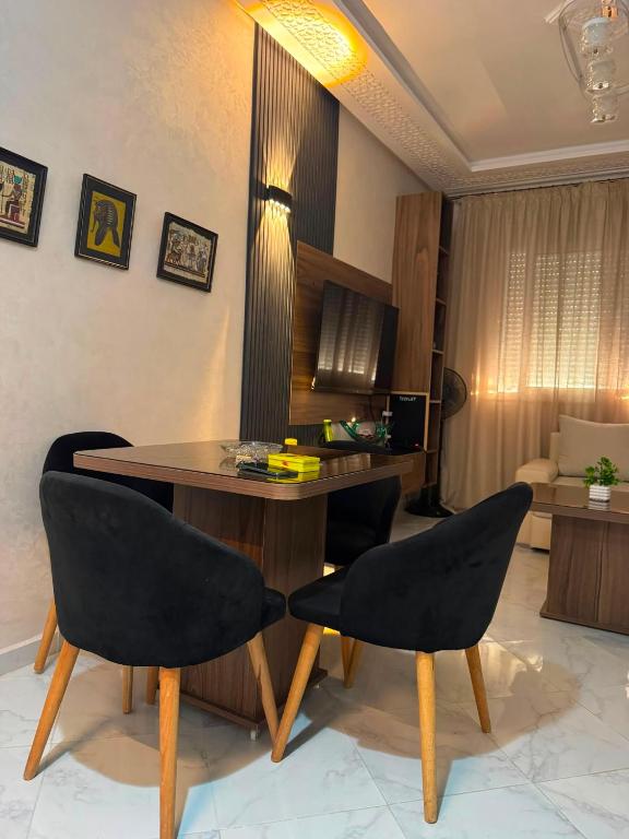 a living room with a table and two chairs at Cozy two bedroom apartment in Meknès