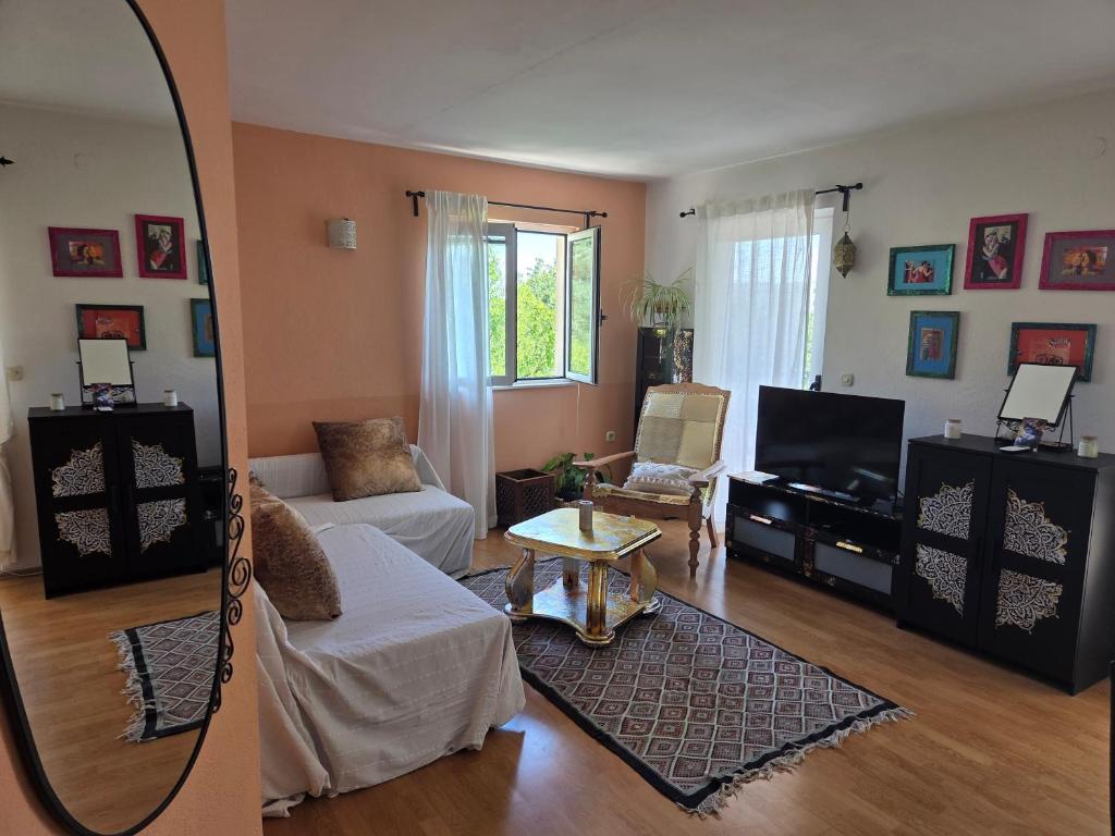 a living room with a couch and a mirror at Babić Rituals apartments in Makarska