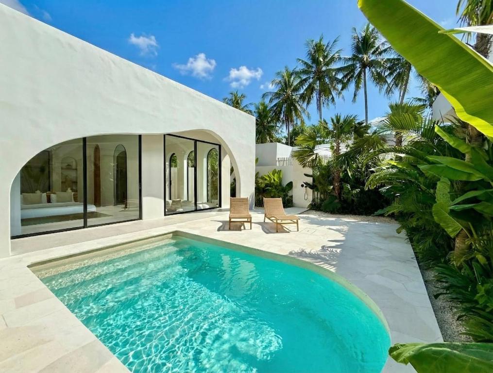 a swimming pool in the backyard of a villa at The Young Villas - 1 Bedroom Villas, Bingin in Uluwatu