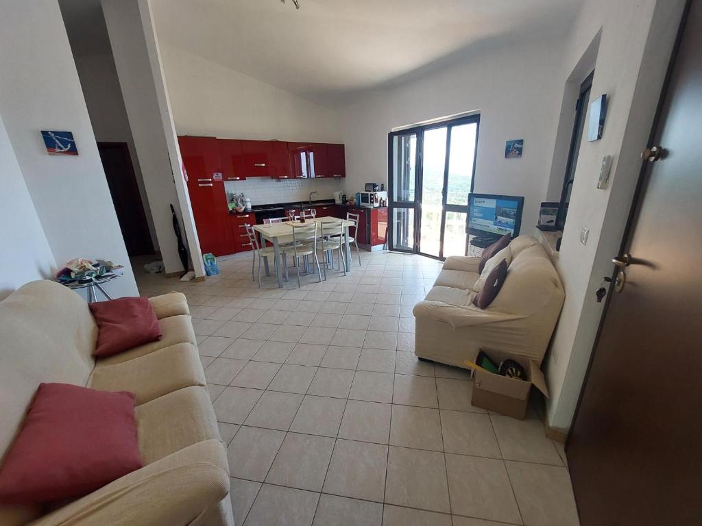 a living room with two couches and a kitchen at Panoramic Sea view Deluxe Apartment in Joppolo in Ioppolo