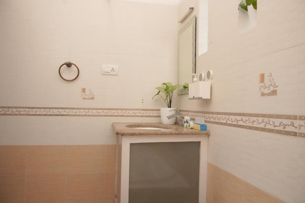 a bathroom with a sink and a mirror at Casa by Cosy Concept in Trivandrum