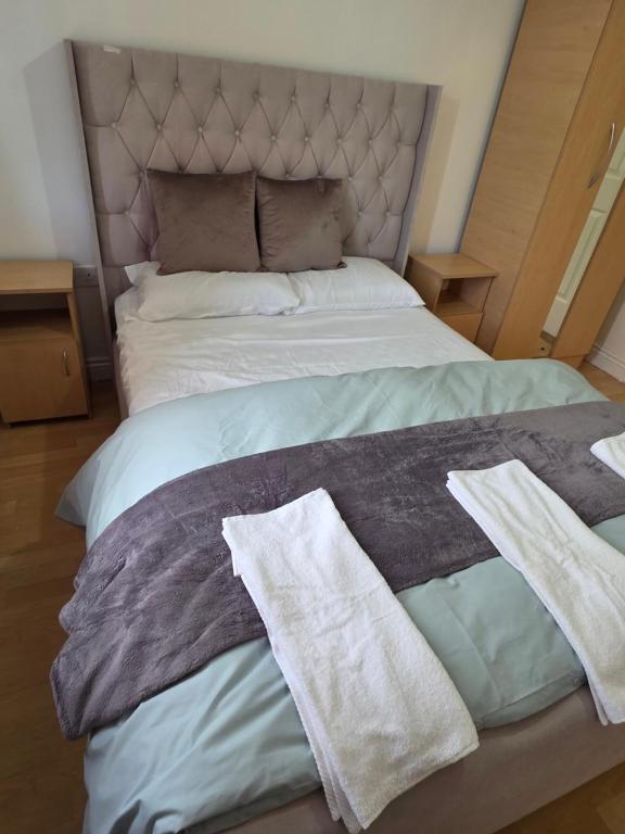 a bed with two towels on top of it at Alex in Castlerea