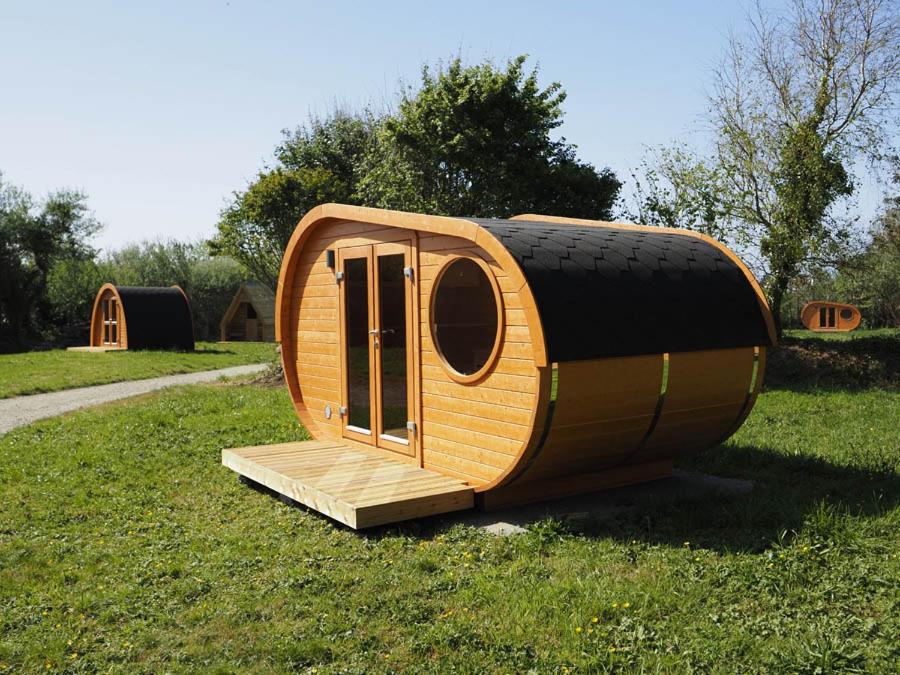 a round house with a tire on the grass at Le Village des Pingouins à Porspoder in Porspoder