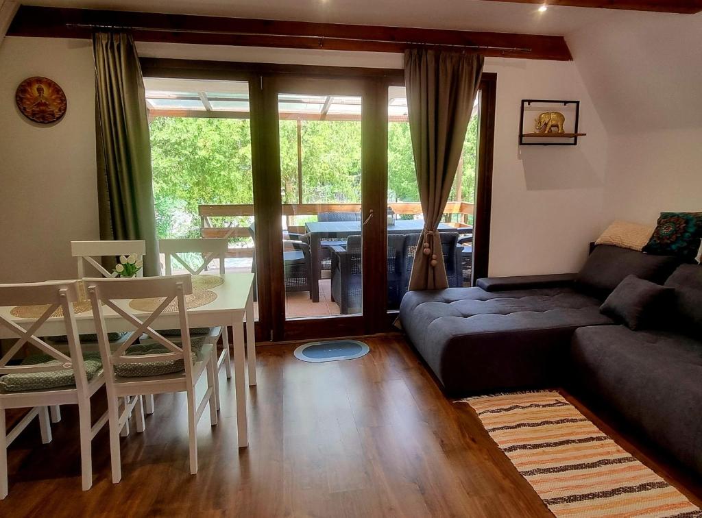 a living room with a couch and a table at Ariel 2 Vendégház in Pilismarót